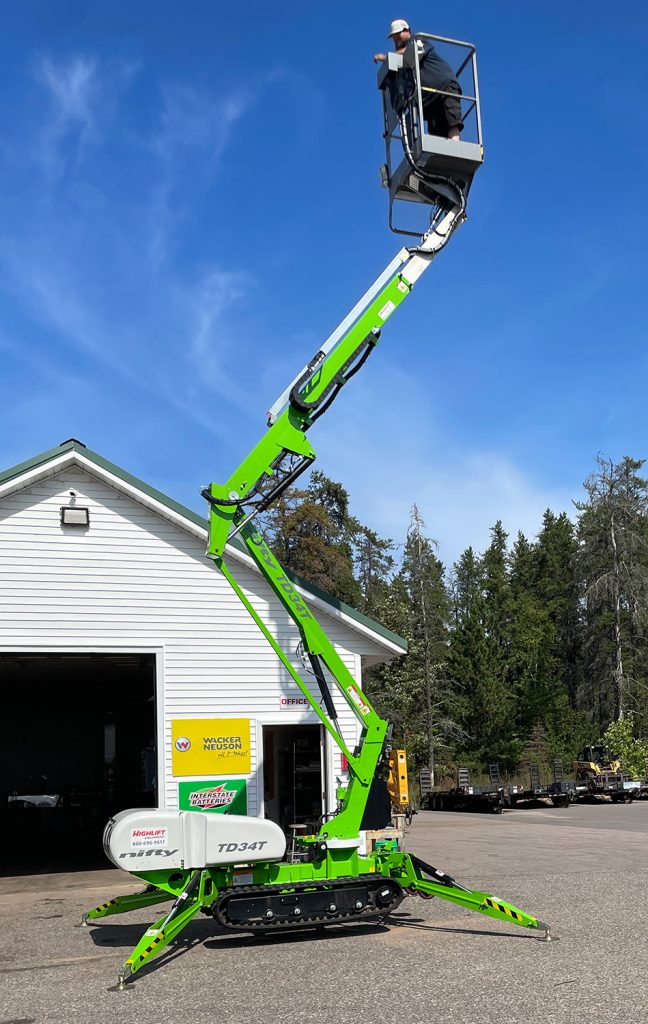 The Nifty TD34T Track Driven Man Lift extending up towards the sky.