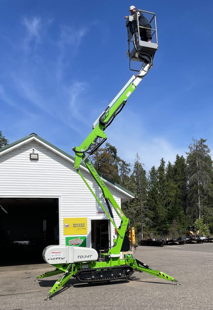 The Nifty TD34T Track Driven Man Lift extending up towards the sky.